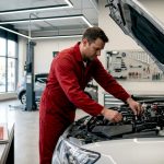 Mechanic performing car tune-up in garage