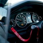 Car dashboard with illuminated check engine light