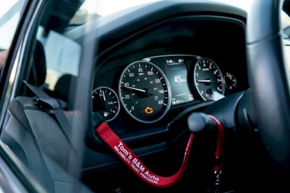 Car dashboard with illuminated check engine light