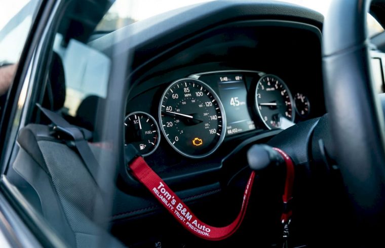 Car dashboard with illuminated check engine light