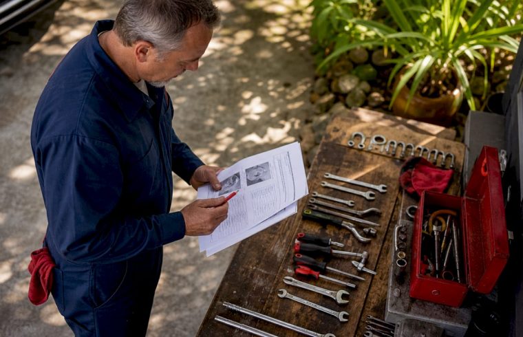 Auto technician reviewing vehicle diagnostic reports