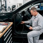 Technician performing vehicle software update diagnostics