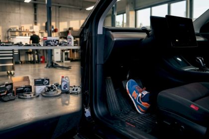 Driver's foot pressing EV brake pedal in workshop