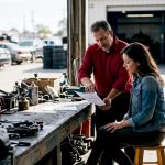 Mechanic explaining repair costs to customer
