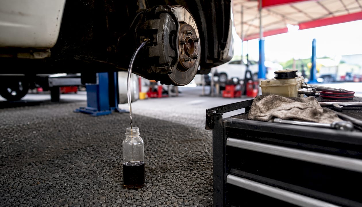 Brake fluid dripping into catch bottle by gravity