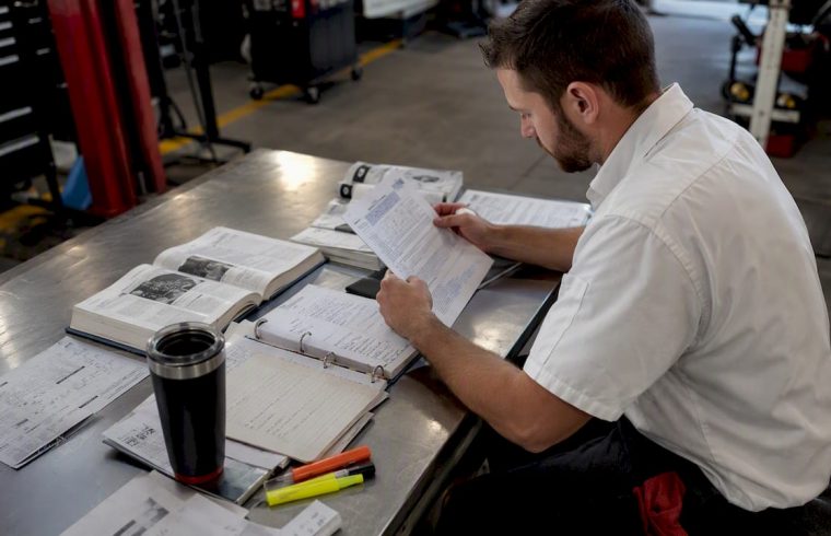 Technician studying ASE certification materials