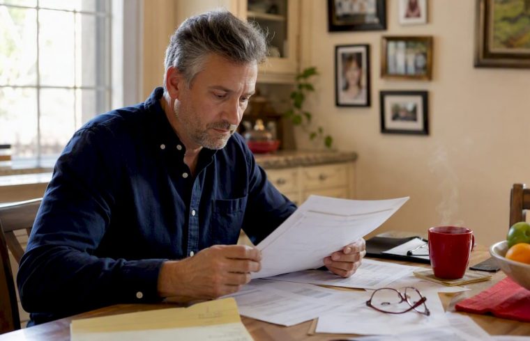 Man reviewing 24,000-mile warranty papers