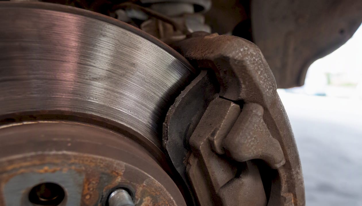 Worn brake pads contacting brake rotor