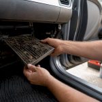 Cabin air filter slot showing dirt and moisture