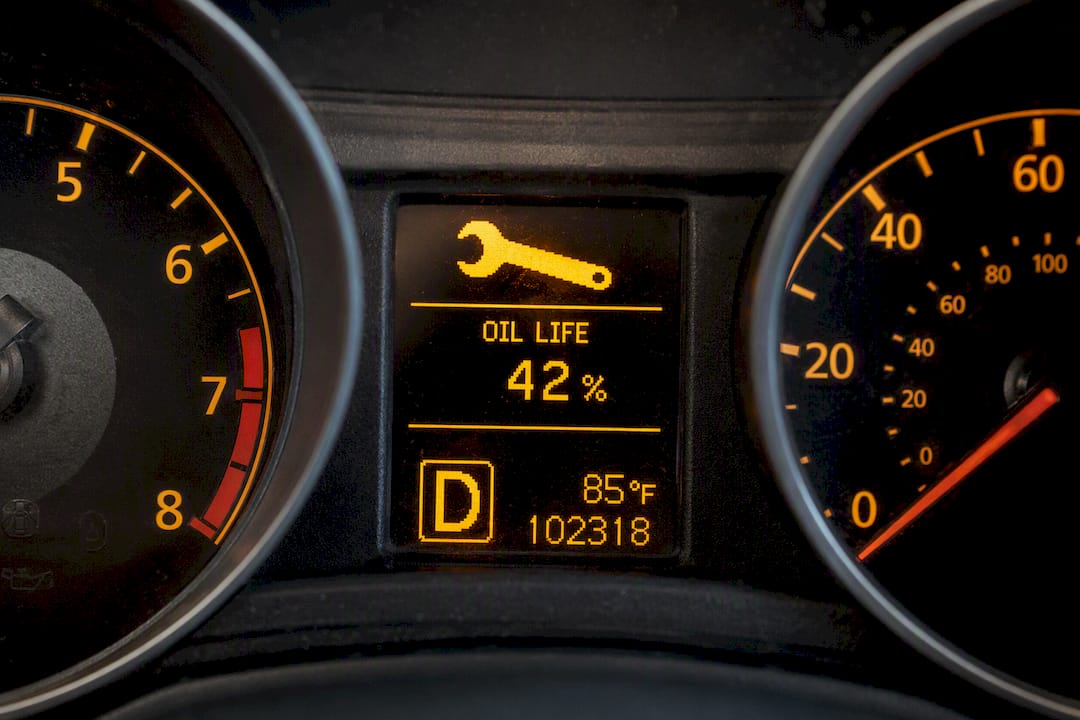 Vehicle dashboard showing oil life and wrench icon
