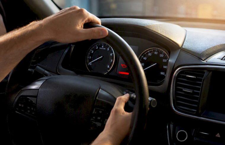 Hands resetting Maintenance Minder on car dashboard
