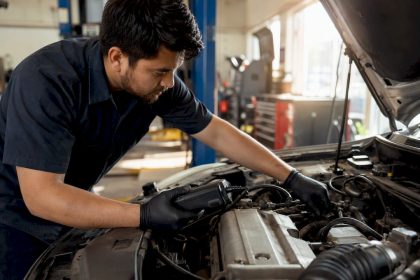 Mechanic connecting diagnostic scanner to engine