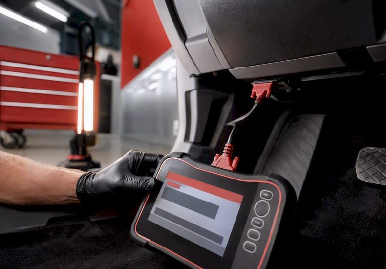 Technician scanning vehicle diagnostic port