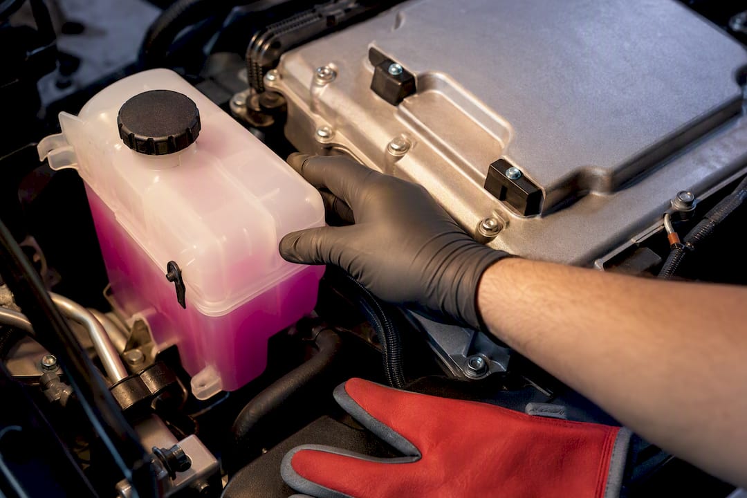 Technician inspecting hybrid cooling components