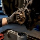 Mechanic inspecting an exposed wheel bearing