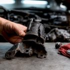 Cracked rubber engine mount under inspection
