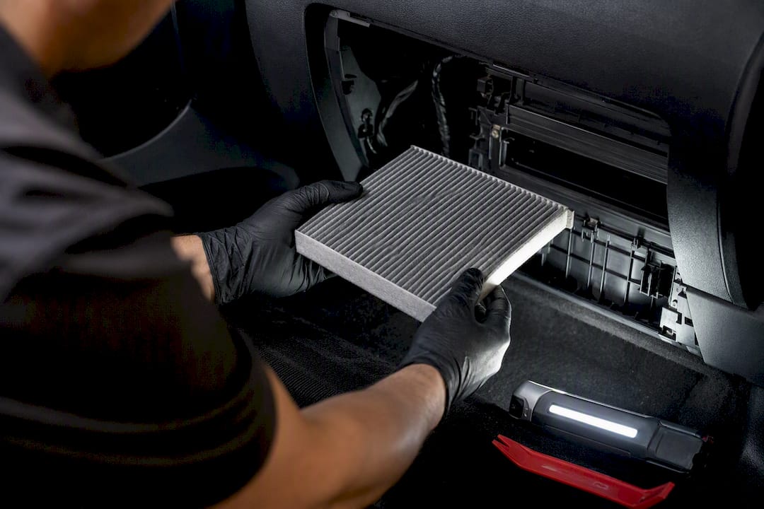 Technician inspecting vehicle cabin air filter