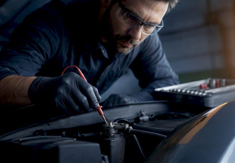 Technician testing a starter cable voltage drop