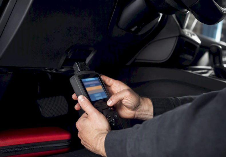 Technician connecting an OBD-II scan tool