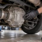 Technician inspecting vehicle rear differential
