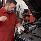 Technician checking oil level in an Audi