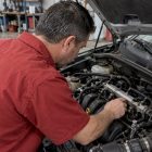 Mechanic inspecting a car’s fuel rail