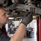 Mechanic checking a cracked suspension bushing
