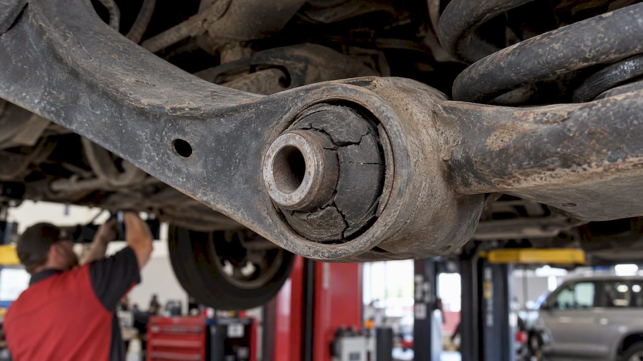 Cracked rubber bushing attached to control arm
