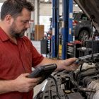 Technician checking oxygen sensor wiring with scan tool