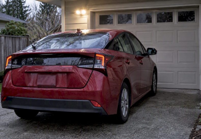 Hybrid parked close to a garage