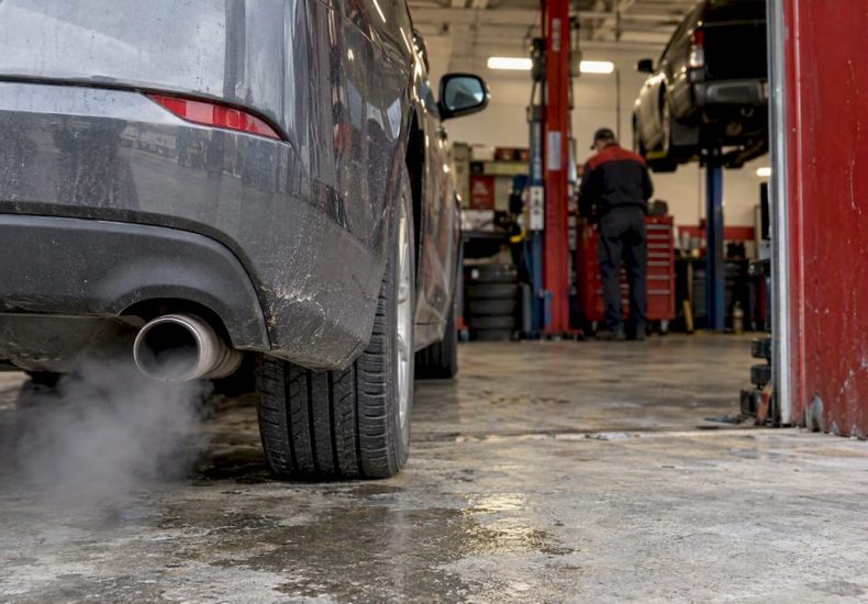 Car tailpipe releasing faint exhaust vapor