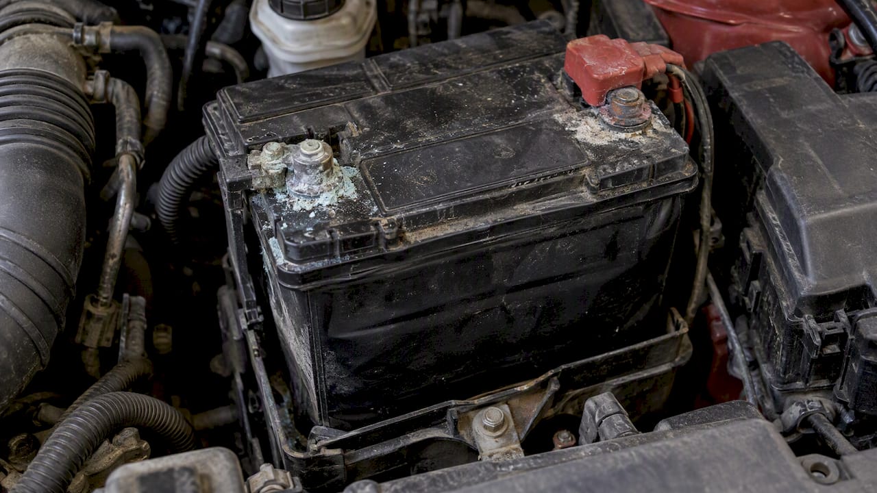 Corroded terminals on a swollen car battery